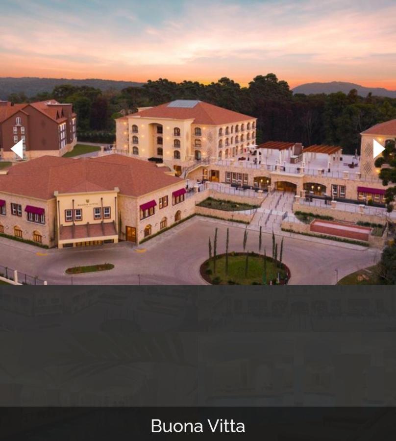 Buona Vitta Gramado Resort & Spa By Gramado Parks Exteriör bild The image shows a large, modern building complex, likely a hotel or resort. The architecture features a combination of traditional and contemporary design elements. Surrounding the main building are landscaped areas, including trees and green spaces,