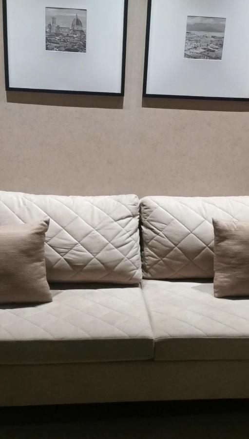 Buona Vitta Gramado Resort & Spa By Gramado Parks Exteriör bild The photo shows a section of a couch with two large, quilted back cushions that have a diamond pattern. There are also two smaller, square pillows placed in front of the back cushions. The color scheme appears to be neutral, featuring shades of beige
